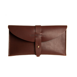 Close-up presents a stylish brown leather clutch featuring a tab closure and the "URBAN Southern" logo.

