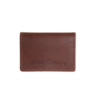 Urban Southern showcases their brown leather cardholder wallet with visible stitching.
