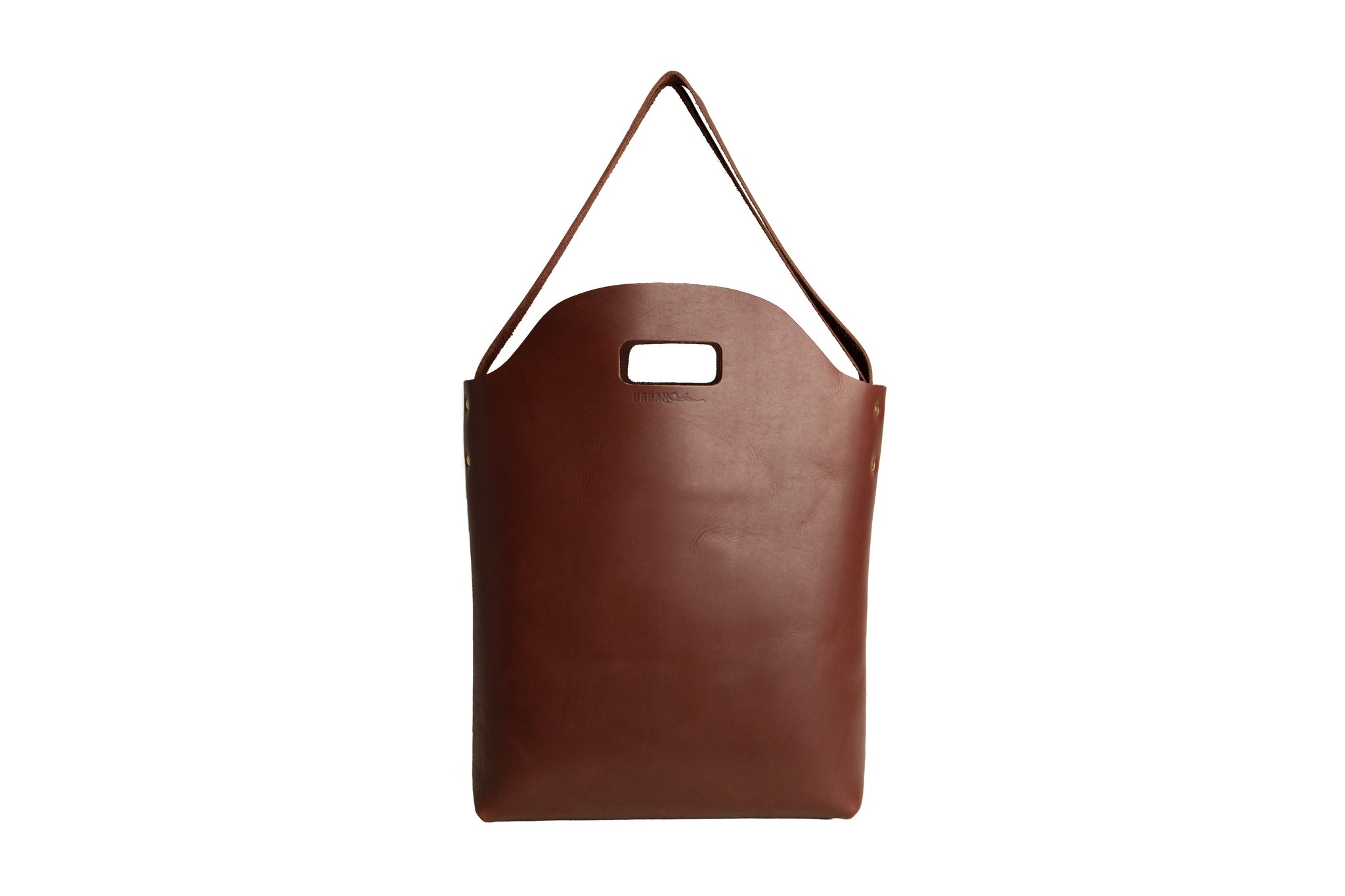 Displays a simple, stylish brown leather tote bag with a handle cutout and shoulder strap.
