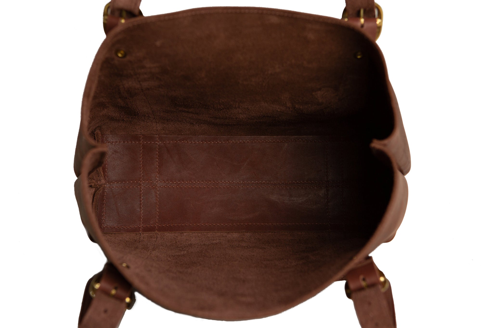 A close-up reveals the spacious interior of a brown leather tote bag, showcasing its quality craftsmanship and potential storage.
