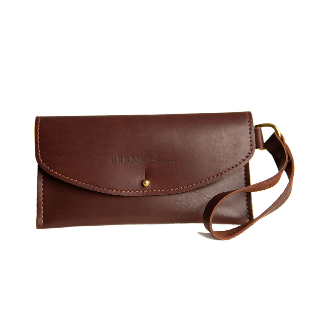 Showcases a stylish brown leather wallet clutch with wrist strap, embossed with the "Urban Southern" logo.
