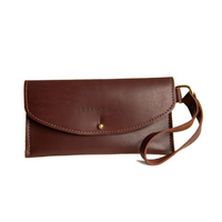 Showcases a stylish brown leather wallet clutch with wrist strap, embossed with the "Urban Southern" logo.
