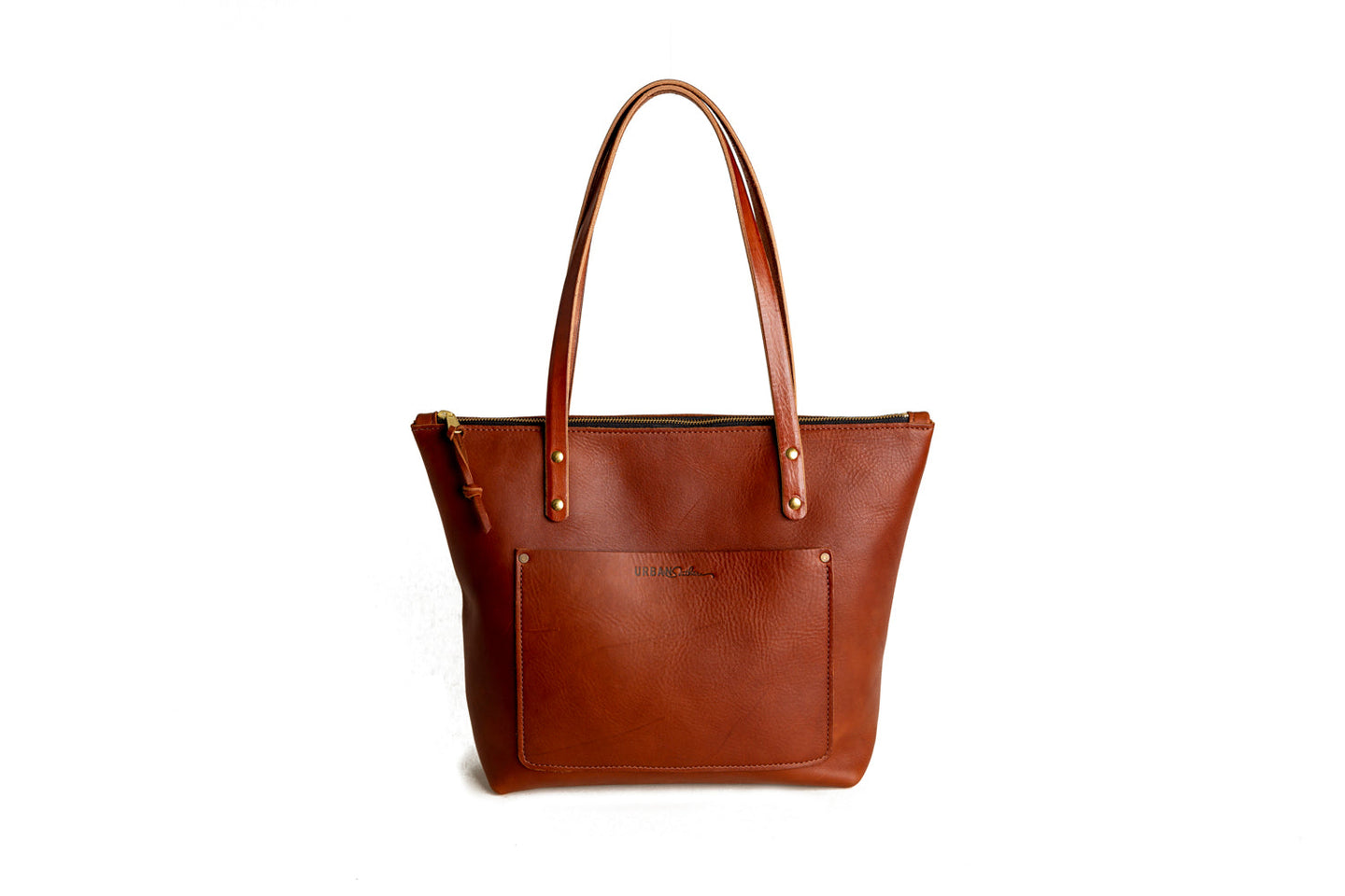 Showcases a stylish, brown leather Urban Southern tote bag with handles and an exterior pocket.
