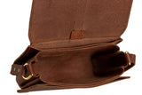 Examine the inside of a handcrafted brown leather satchel bag with the flap open, showcasing its classic design and quality materials.
