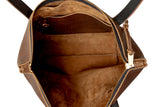 Explore the interior of a brown leather tote bag, showcasing its spacious compartment and interior pocket.
