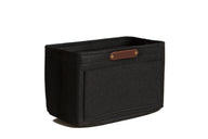 Showcases a black felt handbag organizer insert with a brown leather brand label.
