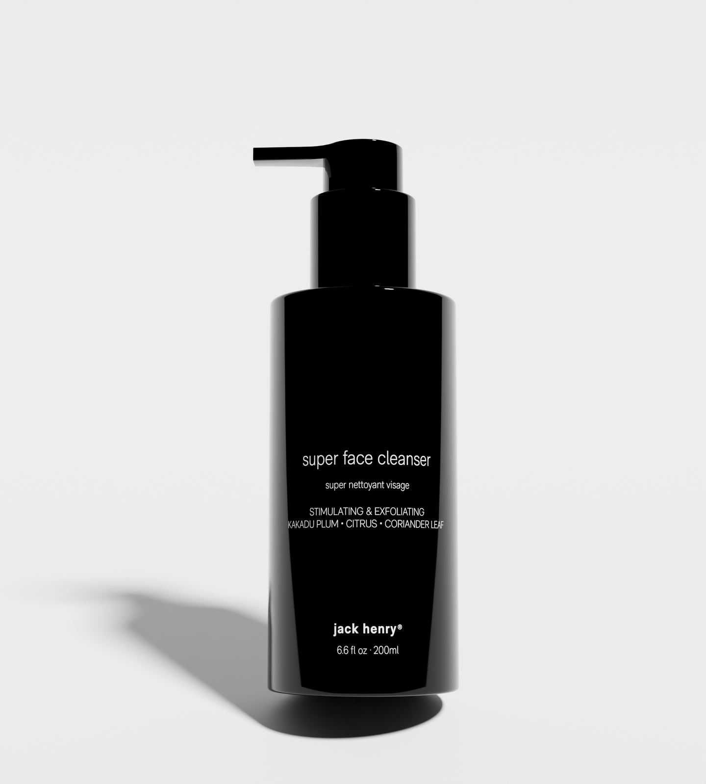 Showcases Jack Henry's Super Face Cleanser, a stimulating and exfoliating face wash with kakadu plum, citrus, and coriander leaf extracts, presented in a sleek black bottle.
