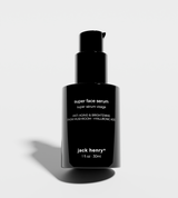 Jack Henry Super Face Serum, an anti-aging and brightening skincare product, sits against a white backdrop.

