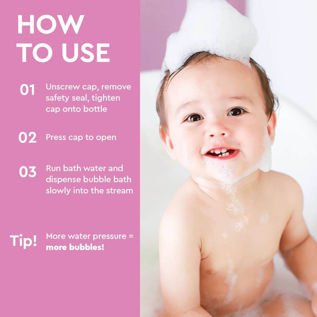 A happy baby enjoys a bubble bath with a foam crown on its head, next to bubble bath instructions.
