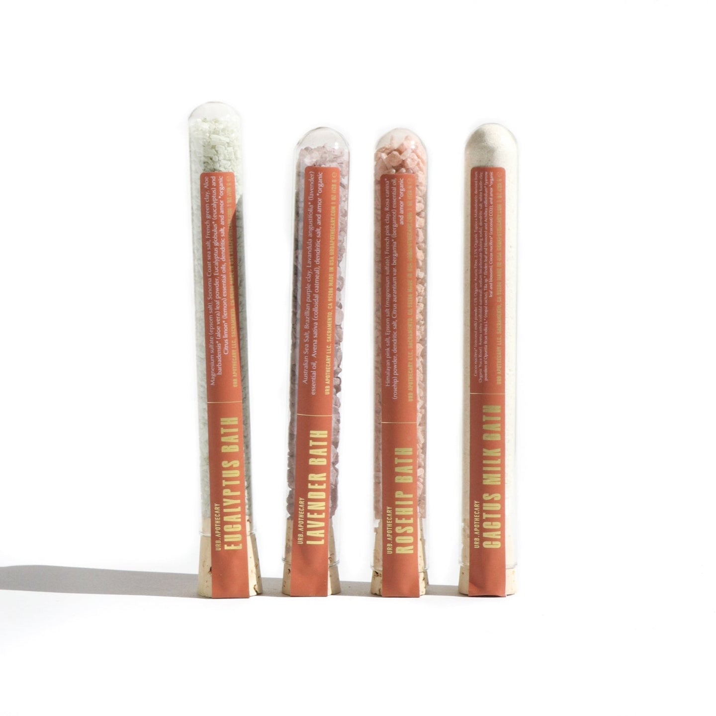 Showcase four tubes of Urb Apothecary bath soaks, including eucalyptus, lavender, rosehip, and cactus milk varieties, displayed against a white background.
